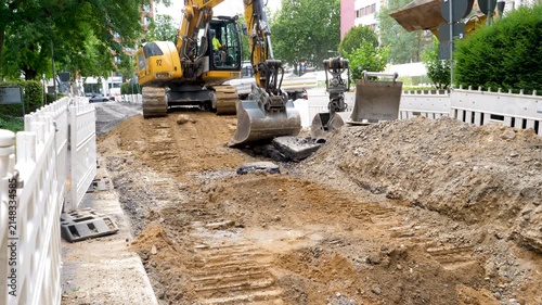 Wiesbaden, Germany - August 06, 2026: Installation of district heating lines in the city center of Wiesbaden. Large construction site, road works and bulldozer.