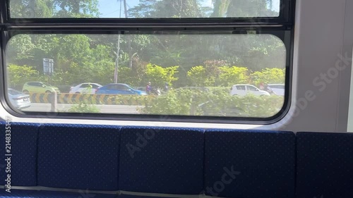Malaysian KTM Komuter electric train arriving at the station platform, public transportation.