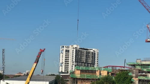 Close up of a massive industrial crawler crane operating at a bridge construction project.