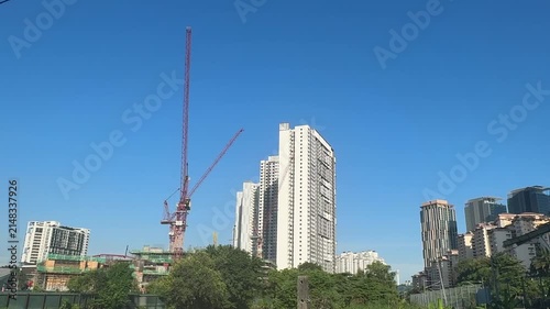 Close up of a massive industrial crawler crane operating at a bridge construction project.