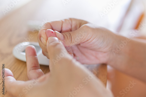 Obraz na płótnie Close up of Squeezing a fingertip to get a blood sample.