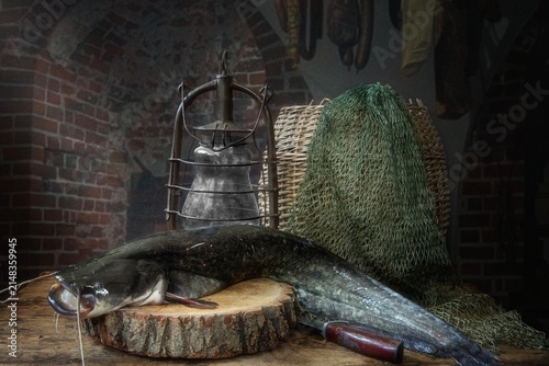 Still life with catfish on a rural table