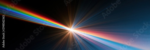 Rainbow light spectrum refracts and explodes into a bright starburst on a dark background