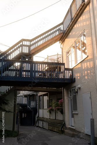 Fotografie Wooden exterior stairways above narrow urban courtyard