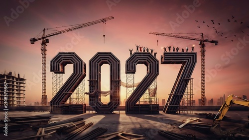 Large 2027 year numbers with construction cranes at sunset