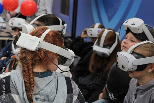 : children are playing computer games using virtual reality glasses