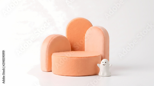 Cute pastel orange geometric arch podium with tiny white ghost figurine on white background
