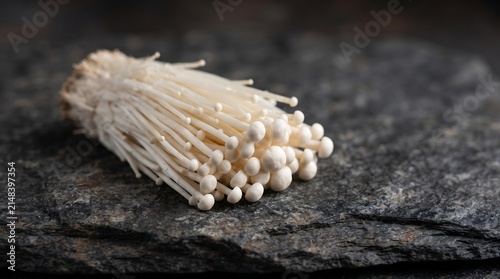Enoki mushrooms on dark stone, organic, healthy, ingredient, food, cooking, fresh, natural, culinary, vegetable.