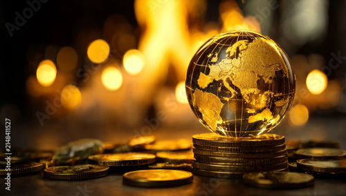 Golden glass globe on stack of coins for global finance