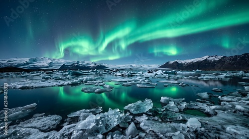 Vibrant green northern lights dancing above a frozen arctic landscape with a reflective icy lake