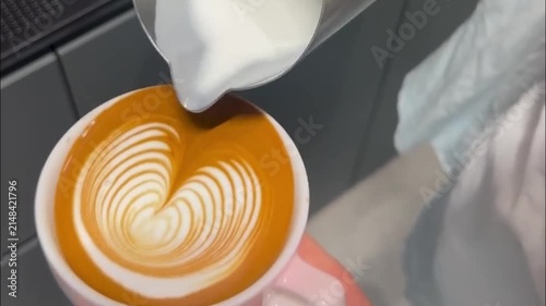 Barista Pouring Steamed Milk to Create Tulip Latte Art Design in Coffee Cup
