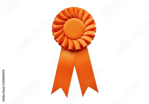 A bright orange ribbon rosette award medal for a competition winner on a plain surface isolated on transparent background