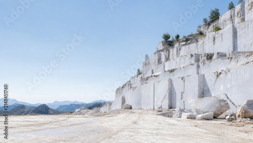 Stone Quarry Landscape Under Clear Blue Sky with Rocky Terrain and Distant Mountains