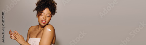 Принти на полотні Beautiful young african american woman enjoying a moment of self care with a con