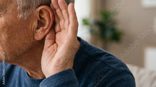 Senior Adult Cupping Ear to Hear Better Close Up
