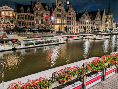 Illuminated Historic Buildings and Canal View with Flowers at Night in Ghent, Belgium
