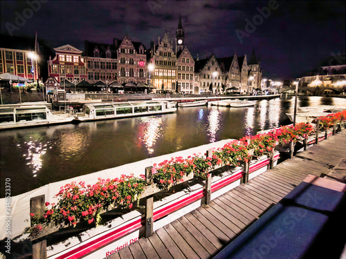 Illuminated Historic Buildings and Canal View with Flowers at Night in Ghent, Belgium