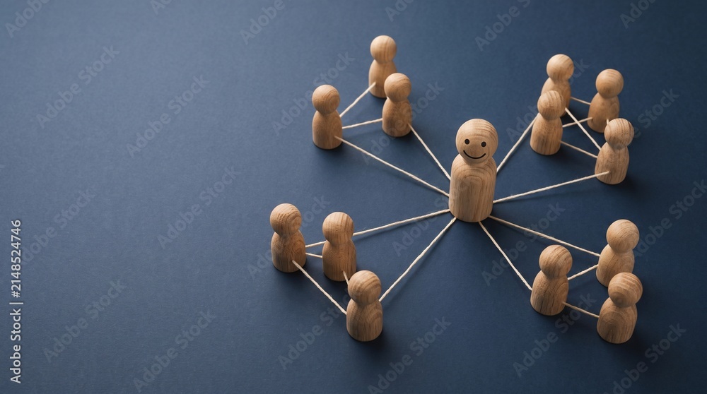 Obraz premium Central wooden figure with smiling face connected to groups of smaller figures through strings on dark blue background.