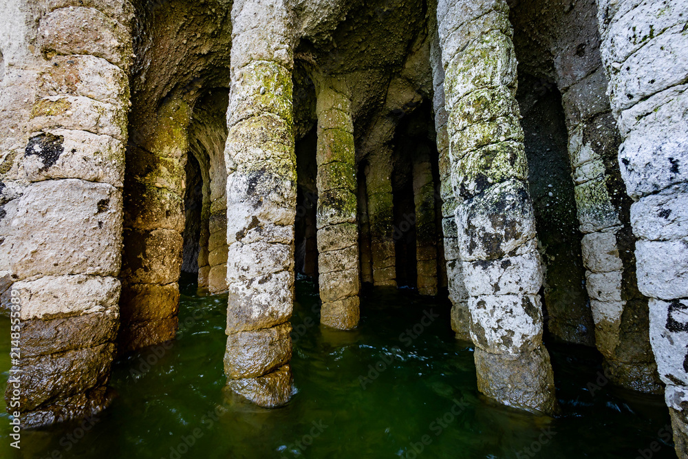 Naklejka premium Natural stone pillars standing in water inside Crowley Lake Stone Columns in California