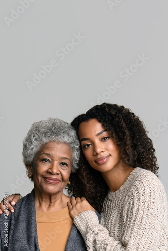 Elderly Black Woman Embraced by Younger Woman in Loving Portrait, Celebrating Generational Bond, Family Connection and Affection with Copy Space, Aspect 2:3