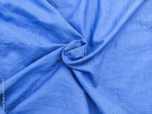 Canvas Print Top view of bright blue wrinkled fabric texture background with elegant swirl folds