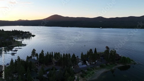 A Drone flight over Big Bear and the Marina showing the recreational areas and the lake at sunset 

