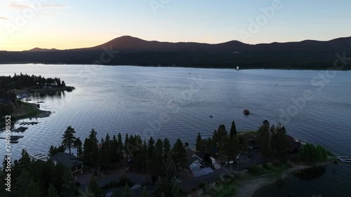 A Drone flight over Big Bear and the Marina showing the recreational areas and the lake at sunset 

