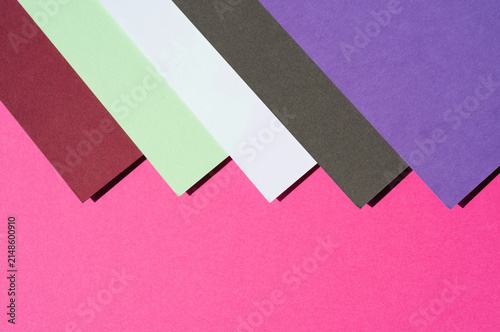 Colored paper, flat cardboard. Stacks of paper sheets of varying thicknesses and colors.
