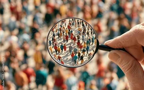 Businessman is studying a crowd of people with a magnifying glass Hr search candidates for work staff recruiting