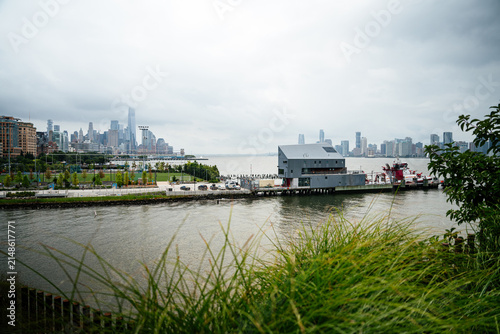 Fotografie Wide view of Manhattan skyline with modern skyscrapers seen from the Hudson River waterfront park