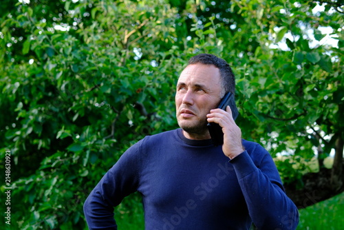 Focused attention and a thoughtful expression suggest an important discussion on the phone. The scene reflects communication decision making responsibility and everyday modern life.