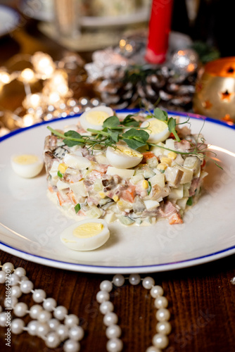 Canvastavla Traditional Olivier salad with quail eggs on Christmas table