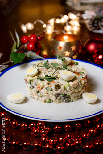 Cuadro en lienzo Traditional Olivier salad with quail eggs on Christmas table