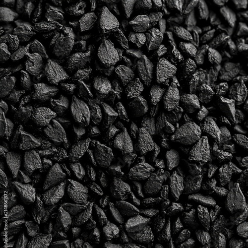 Extreme macro photography of raw black cumin seeds showing unique shape and texture in dark background