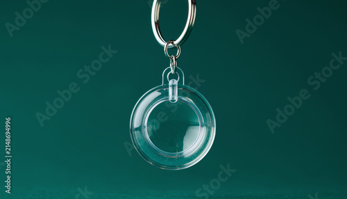 Minimalist Glass Pendant Keychain Against Green Background.