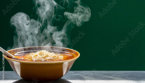 Steaming Bowl of Curry on a Green Backdrop.