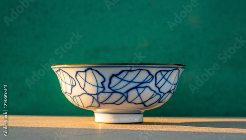 Blue and white porcelain bowl on pedestal.