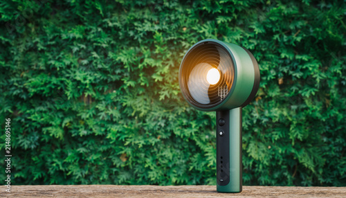 Modern lamp against lush ivy covered wall at dusk.