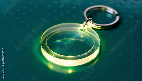 Glowing Green Ring with Metal Clasp Submerged in Water.