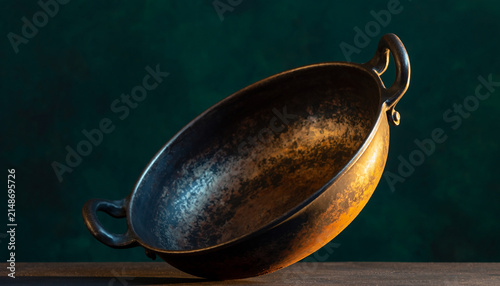 Sturdy Metal Pan Resting on Dark Surface.