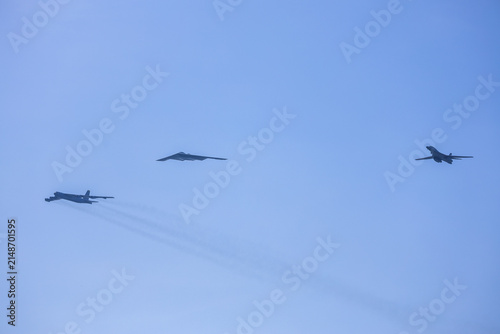Jersey City, New Jersey, United States - 04 July 2026: View of military aircraft including a B-2 Spirit stealth bomber and other jets flying in formation against a clear blue sky during a flyover.