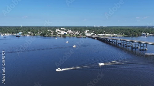 Boats near the Memorial Bridge on the St Johns River with historic downtown Palatka in the background in Putnam County, Florida. 