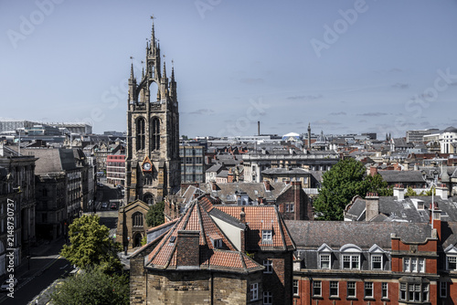 Aerial view of St. Nicholas Cathedral surrounded by historic red-tiled rooftops and urban architecture in Newcastle upon Tyne, England, United Kingdom.