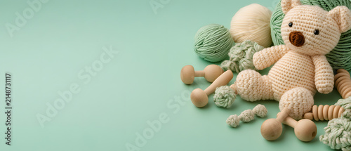 Eco friendly handmade baby toys on a mint background.