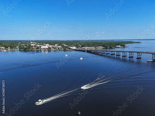 Boats near the Memorial Bridge on the St Johns River with historic downtown Palatka in the background in Putnam County, Florida. 