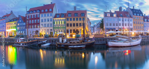 Nyhavn harbor panorama with colorful waterfront buildings at dawn in Copenhagen Denmark