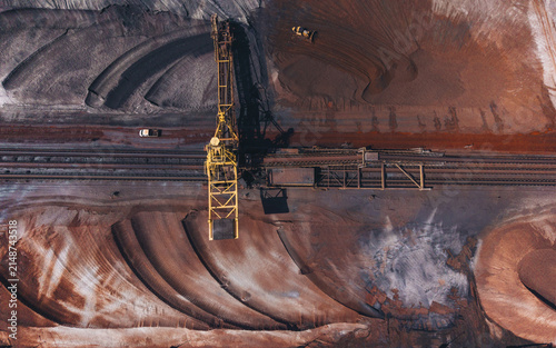 Aerial view of Tata Steel industrial site with heavy machinery, raw material piles, and railway tracks in Velsen-Noord, Noord-Holland, Netherlands.