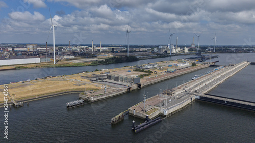 Aerial view of Sluizencomplex IJmuiden featuring the large lock system, industrial infrastructure, and wind turbines along the canal in IJmuiden, Noord-Holland, Netherlands.
