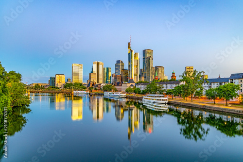 scenic skyline of Frankfurt am Main in early morning light and reflection in river Main