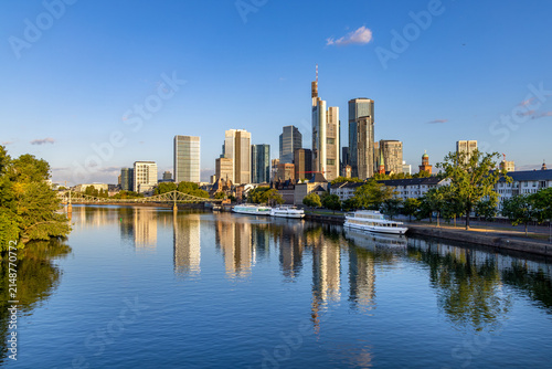 scenic skyline of Frankfurt am Main in early morning light and reflection in river Main